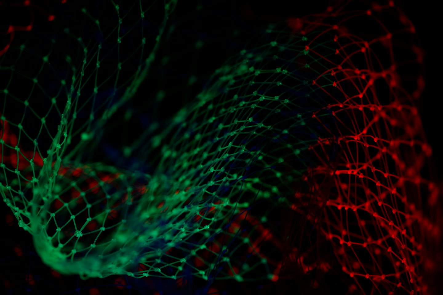 Glowing green and red digital network on a black background.